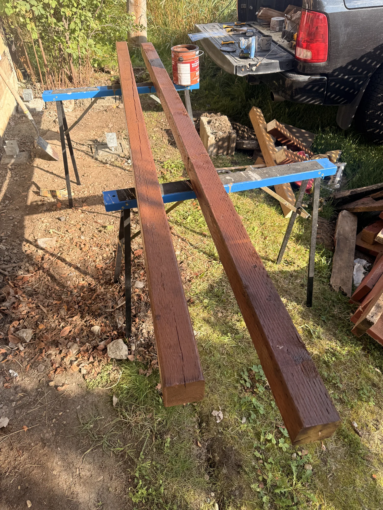 Two frame beams up on trestles after their first coat of stain