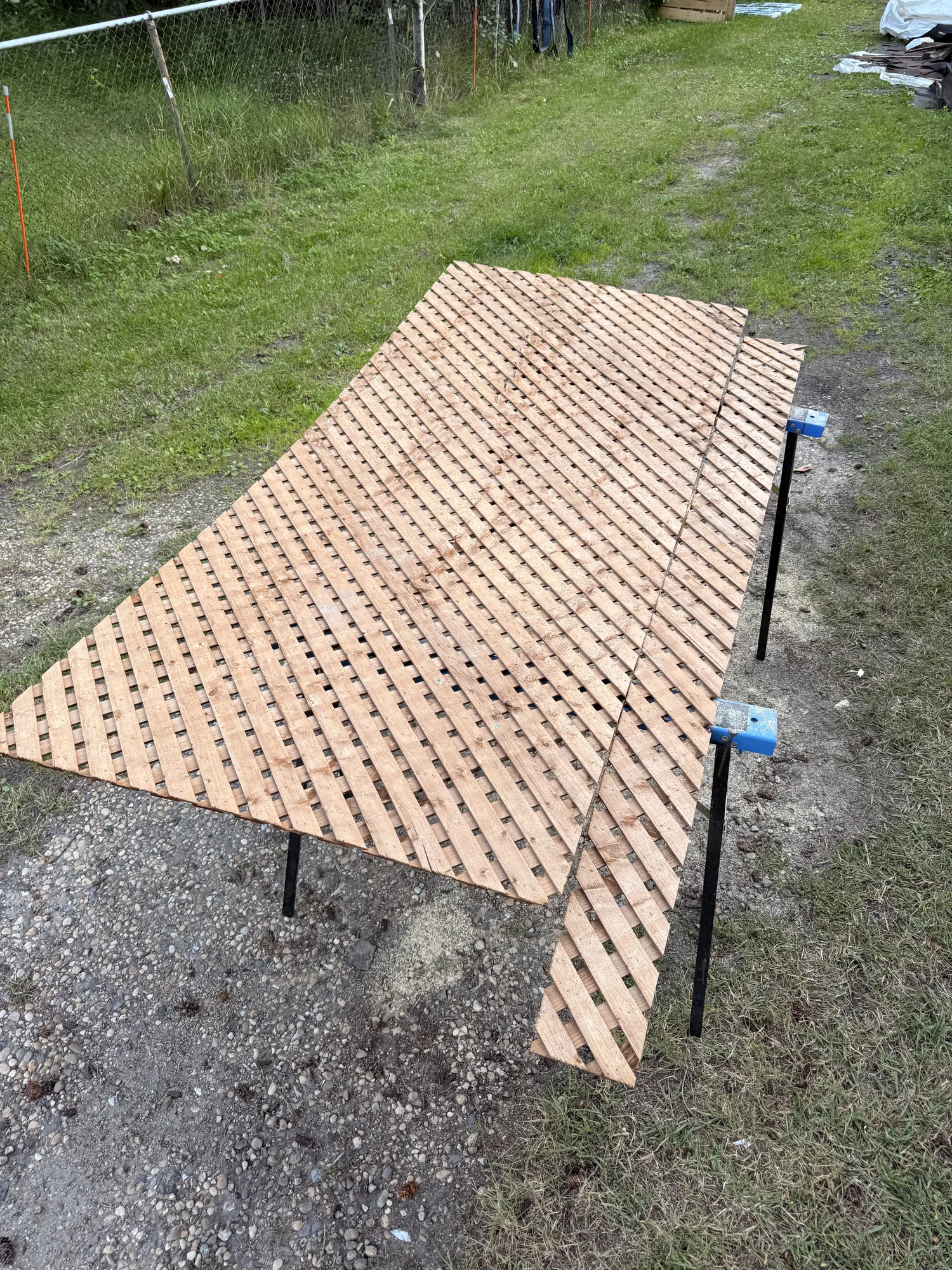 The pressure-treated lattice panel laid out on the grass