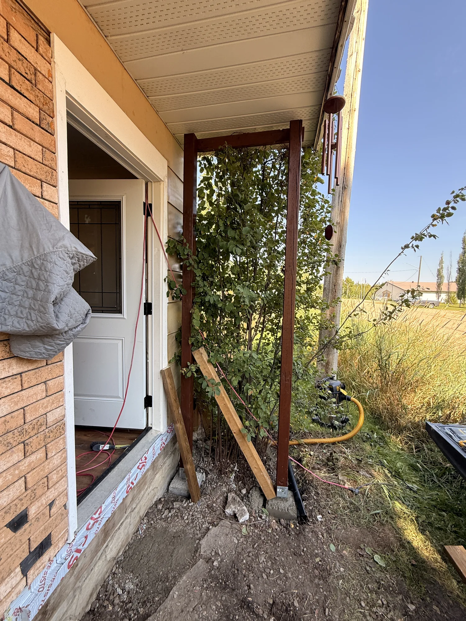 The first stained posts standing against the side of the house