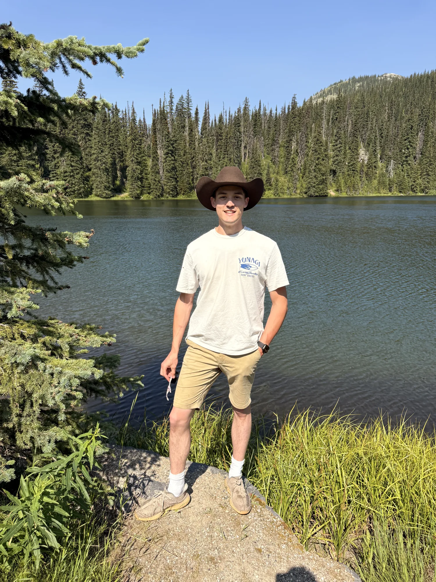 Standing beside the still lake at the top of Kootenay Pass