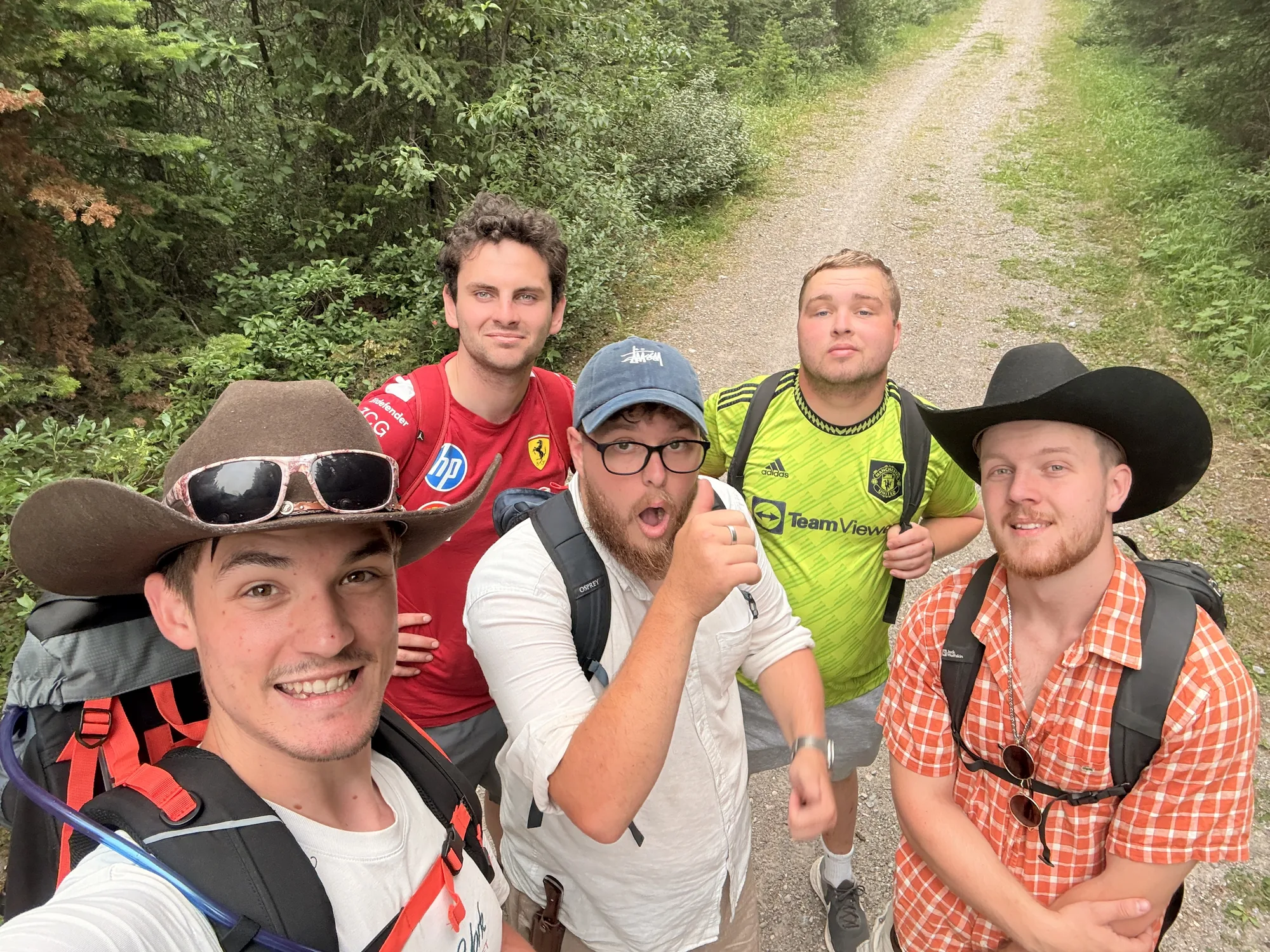 The five of us on the gravel trail near Lake Minnewanka, packs on