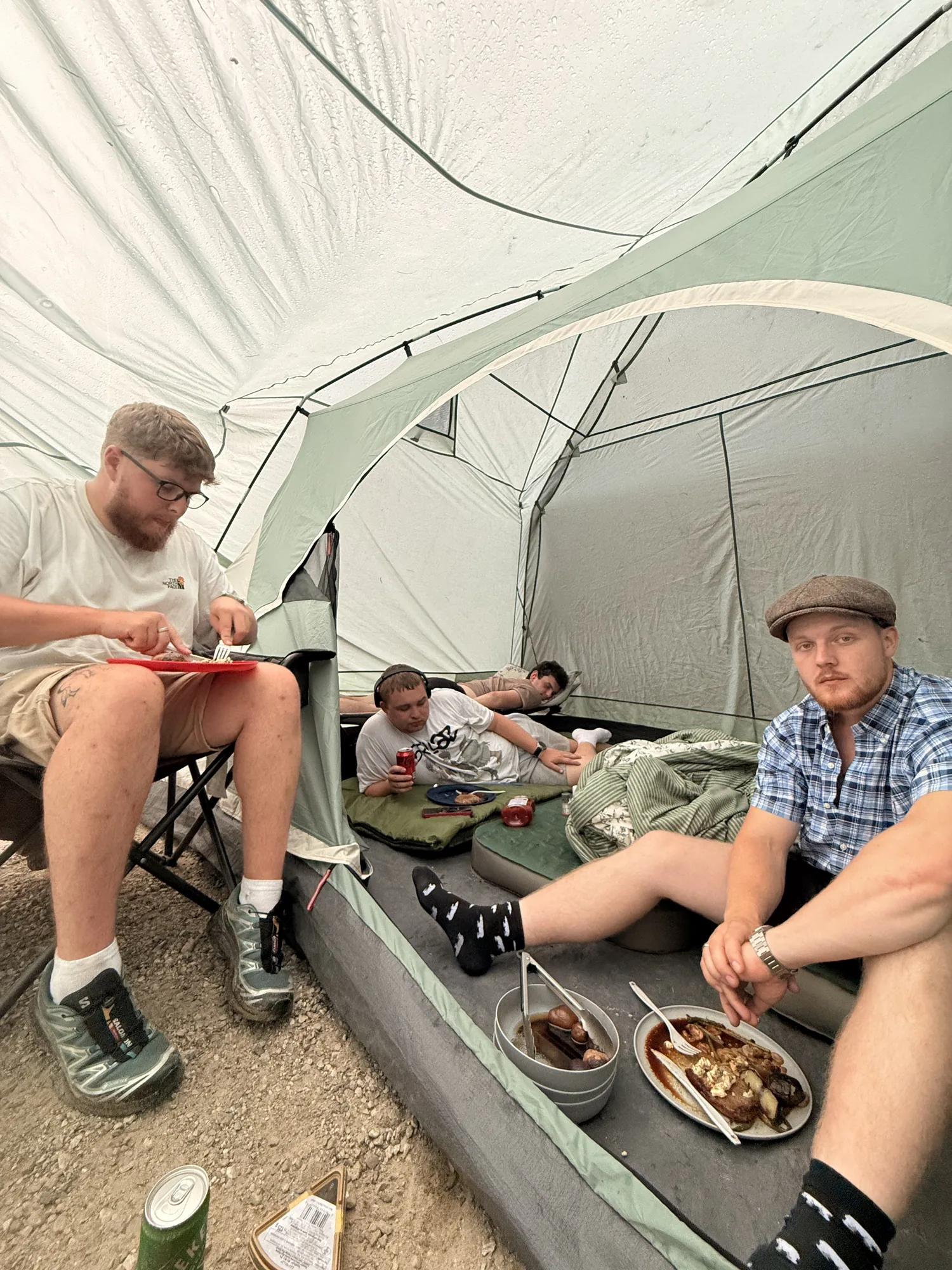 Eating dinner in camp chairs inside the big tent at Revelstoke
