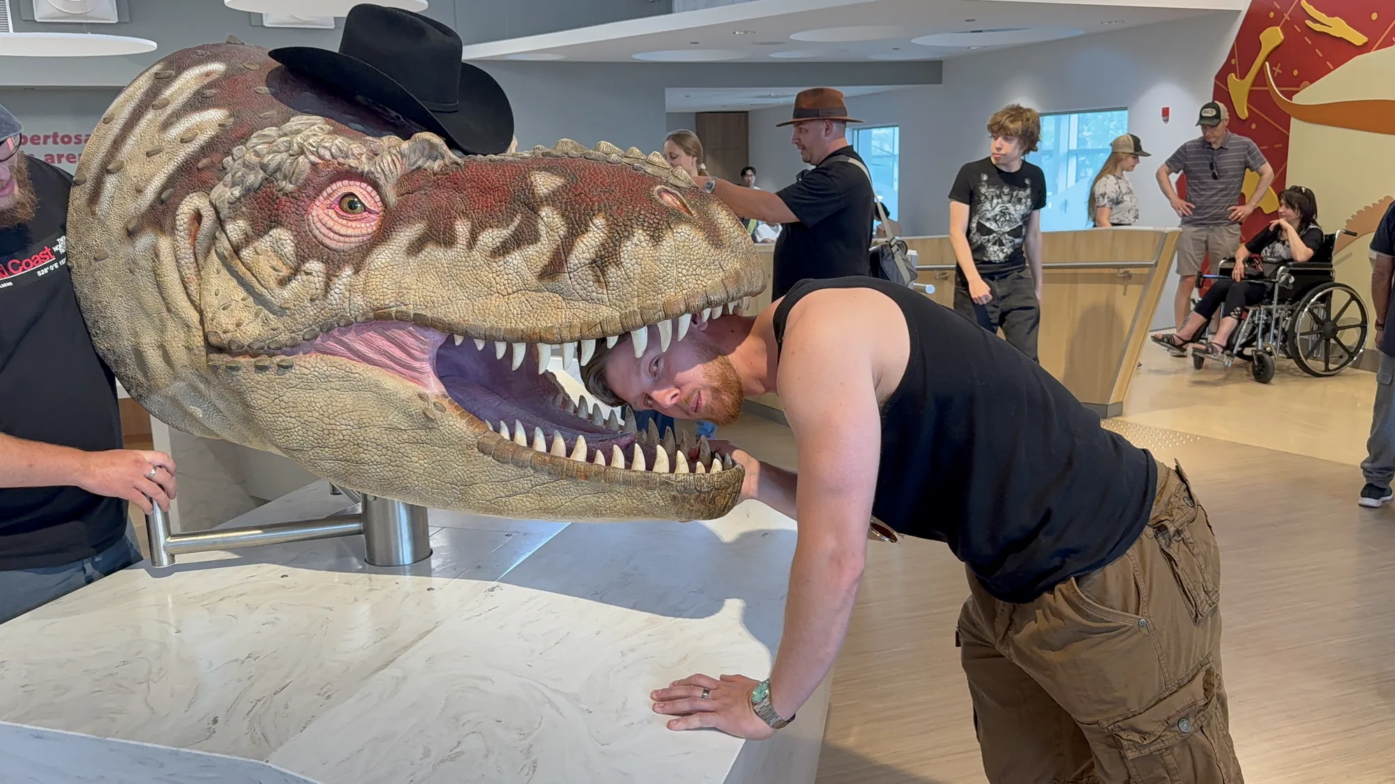 Pretending to be eaten by a Tyrannosaurus skull at the Royal Tyrrell Museum