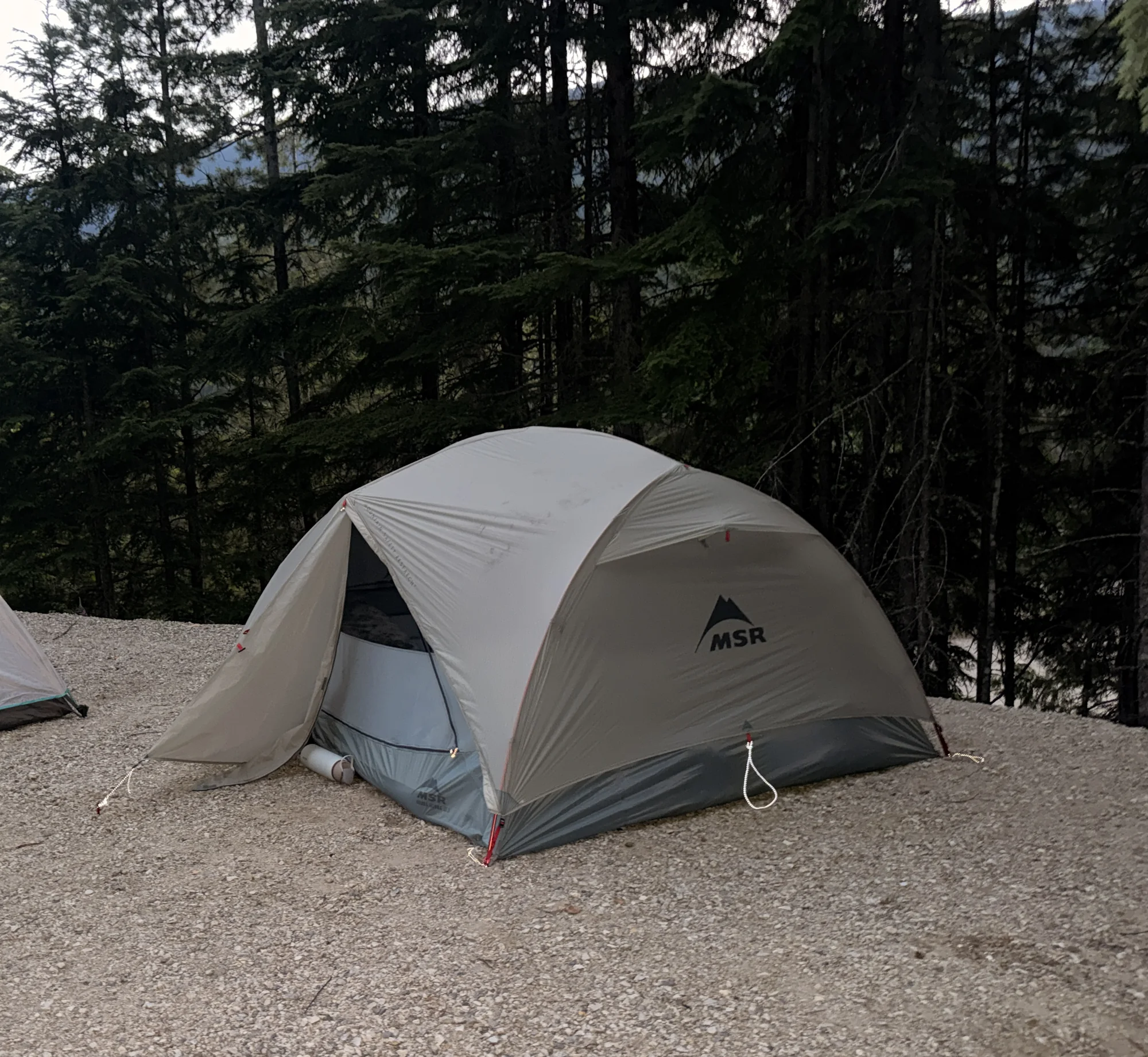 The MSR Hubba Hubba 3 pitched on a gravel campsite pad at Revelstoke, vestibule open