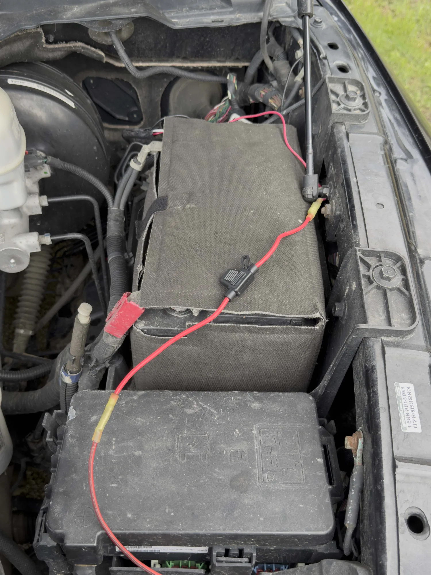 Power cable run from the battery through an inline fuse to the fuse box under the hood